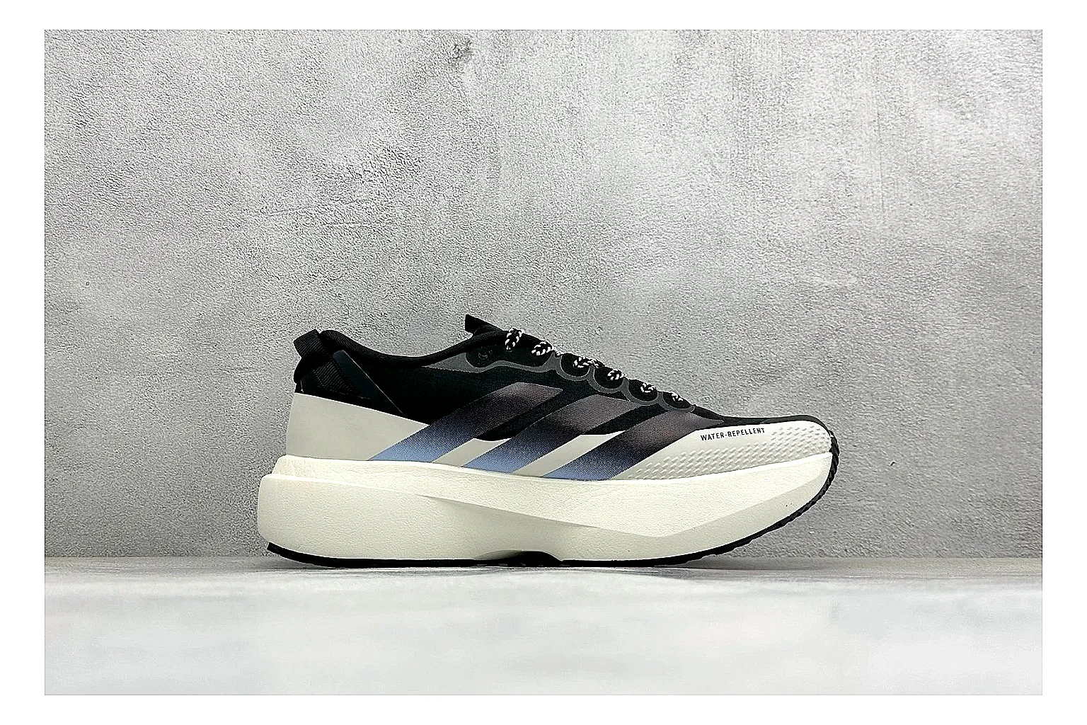 Adidas Adizero Evo Black comparison photo showing black racing upper, sculpted white sole, Adidas striping, and lightweight performance silhouette thumbnail 6