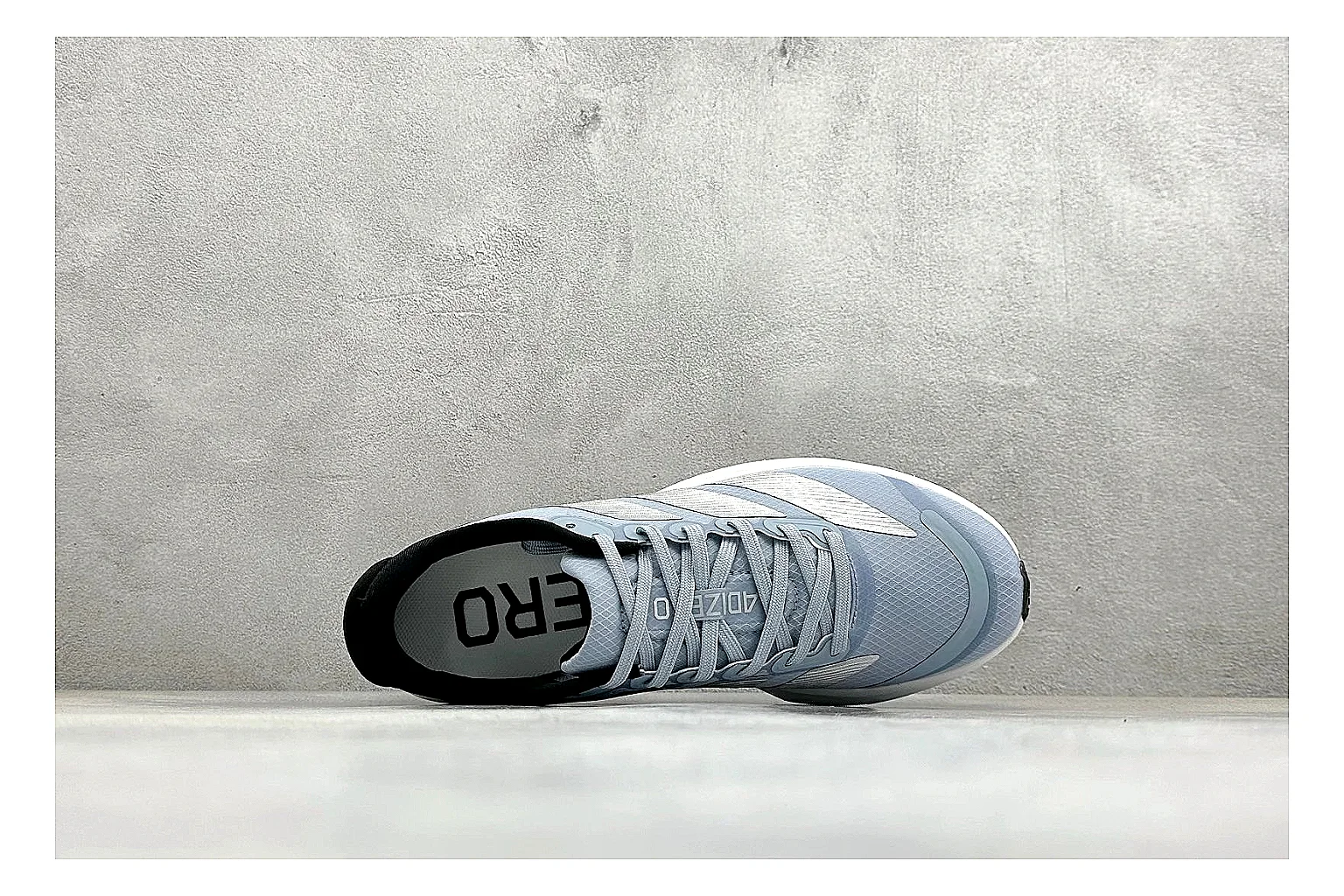 Adidas Adizero Grey Blue comparison photo showing grey lightweight runner upper, blue Adidas striping, slim racing shape, and low performance sole