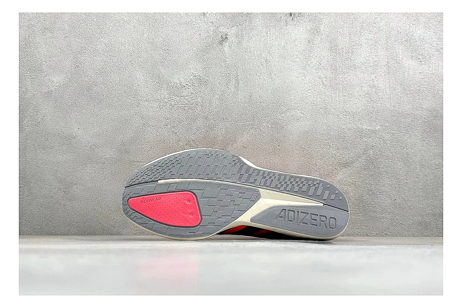 Adidas Adizero Orange Black comparison photo showing orange runner upper, black three-stripe contrast, lightweight racing shape, and thin performance sole thumbnail 4