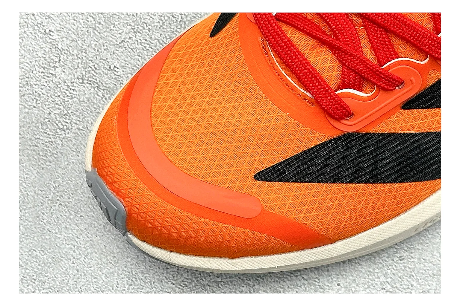 Adidas Adizero Orange Black comparison photo showing orange runner upper, black three-stripe contrast, lightweight racing shape, and thin performance sole thumbnail 5