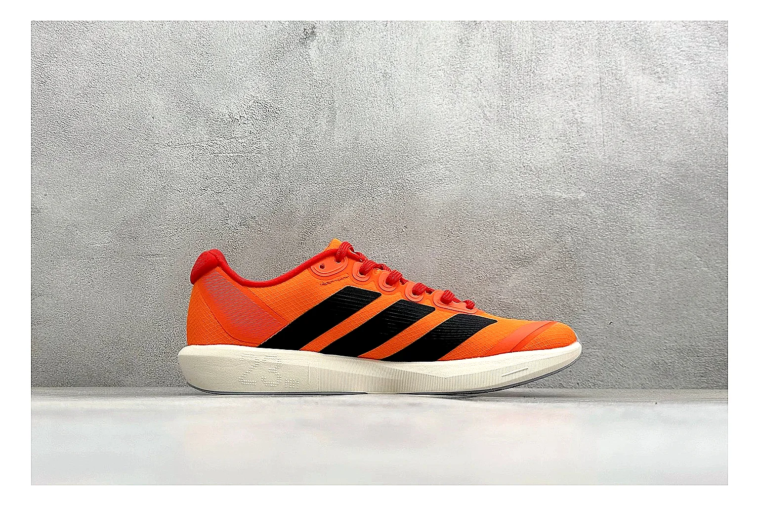 Adidas Adizero Orange Black comparison photo showing orange runner upper, black three-stripe contrast, lightweight racing shape, and thin performance sole thumbnail 6