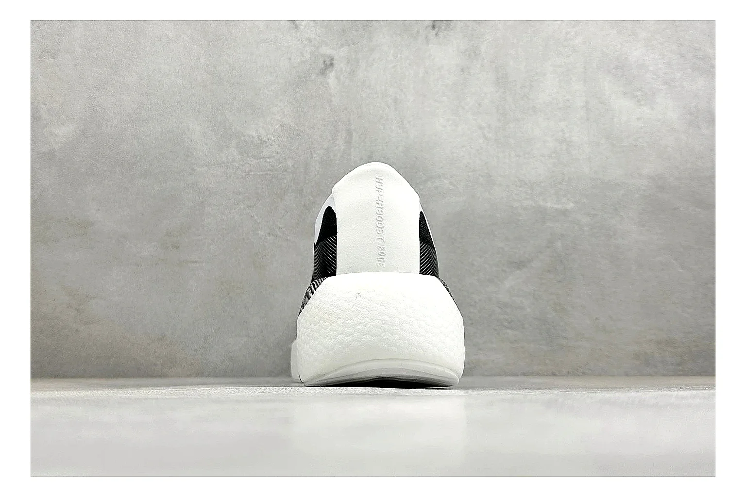 Adidas Hyper Boost White Black comparison photo showing white knit runner upper, black Adidas striping, sculpted Boost-style sole, and modern low runner profile thumbnail 3