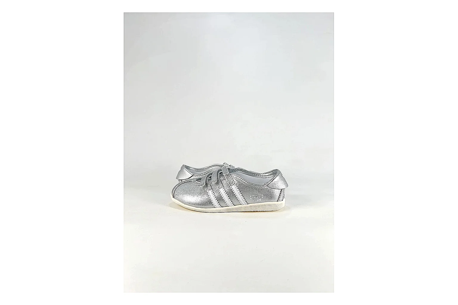 Adidas Originals Anfisa Silver Sneakers comparison signal photo with silver low-top sneakers with leather texture, side-profile shape, upper panel lines, and outsole detail