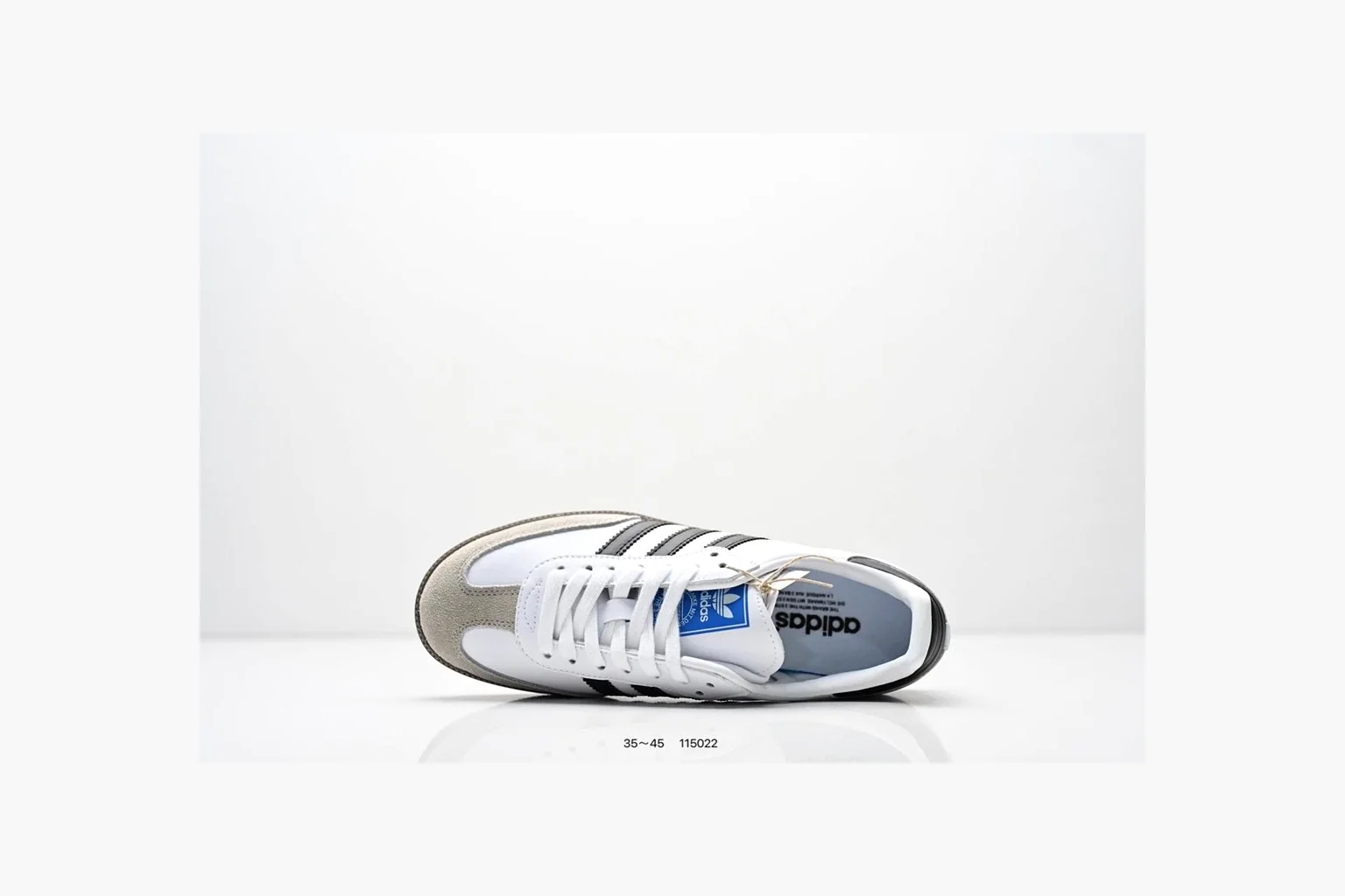 Adidas Samba OG White Black Blue comparison photo showing white leather-suede low-top upper, black three stripes, blue heel detail, gum terrace sole, and slim Samba profile