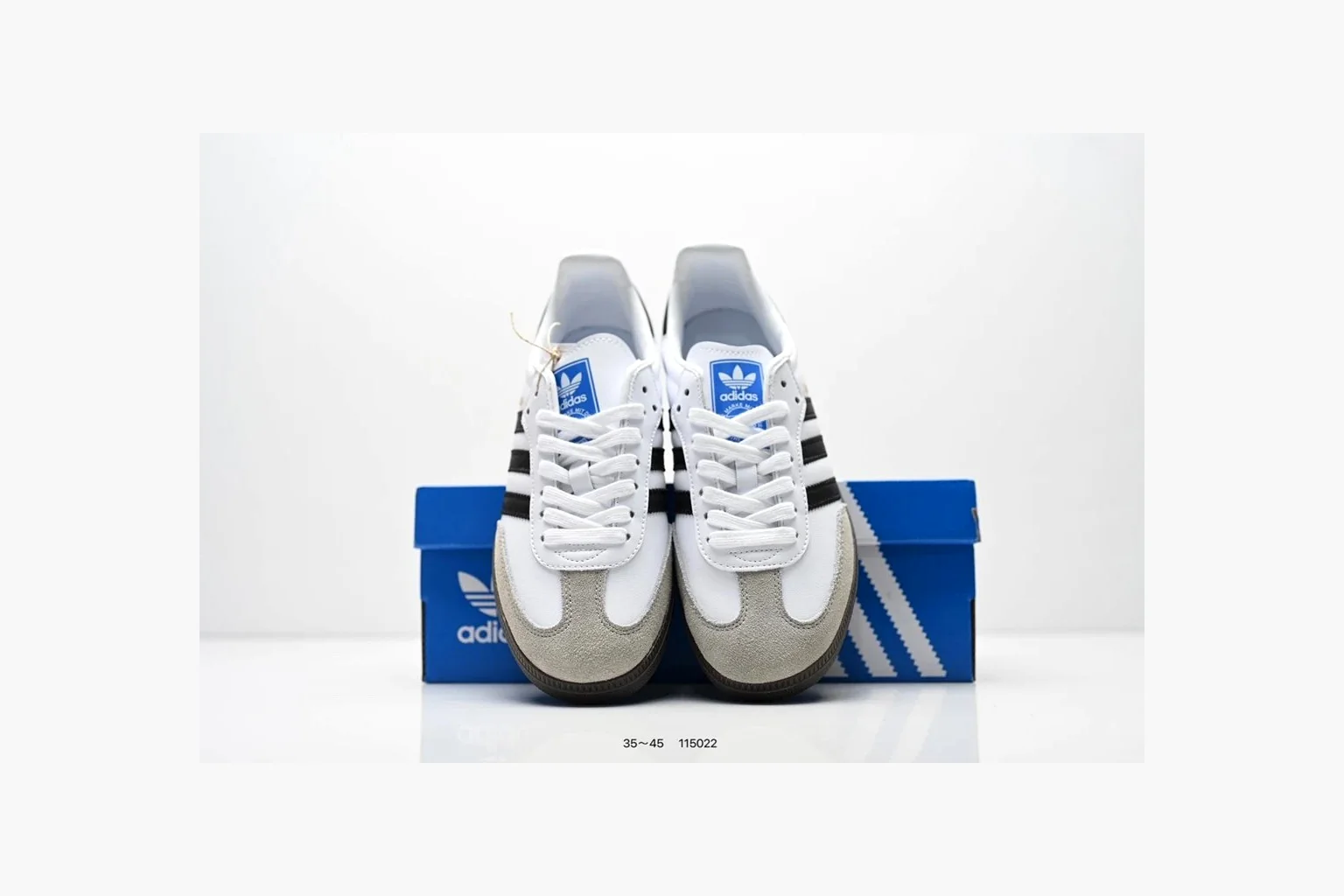 Adidas Samba OG White Black Blue comparison photo showing white leather-suede low-top upper, black three stripes, blue heel detail, gum terrace sole, and slim Samba profile thumbnail 5