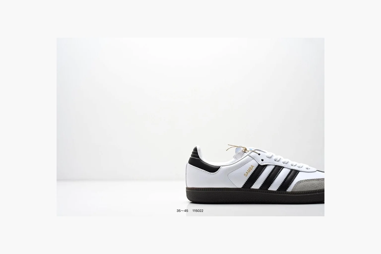 Adidas Samba OG White Black Blue comparison photo showing white leather-suede low-top upper, black three stripes, blue heel detail, gum terrace sole, and slim Samba profile thumbnail 6
