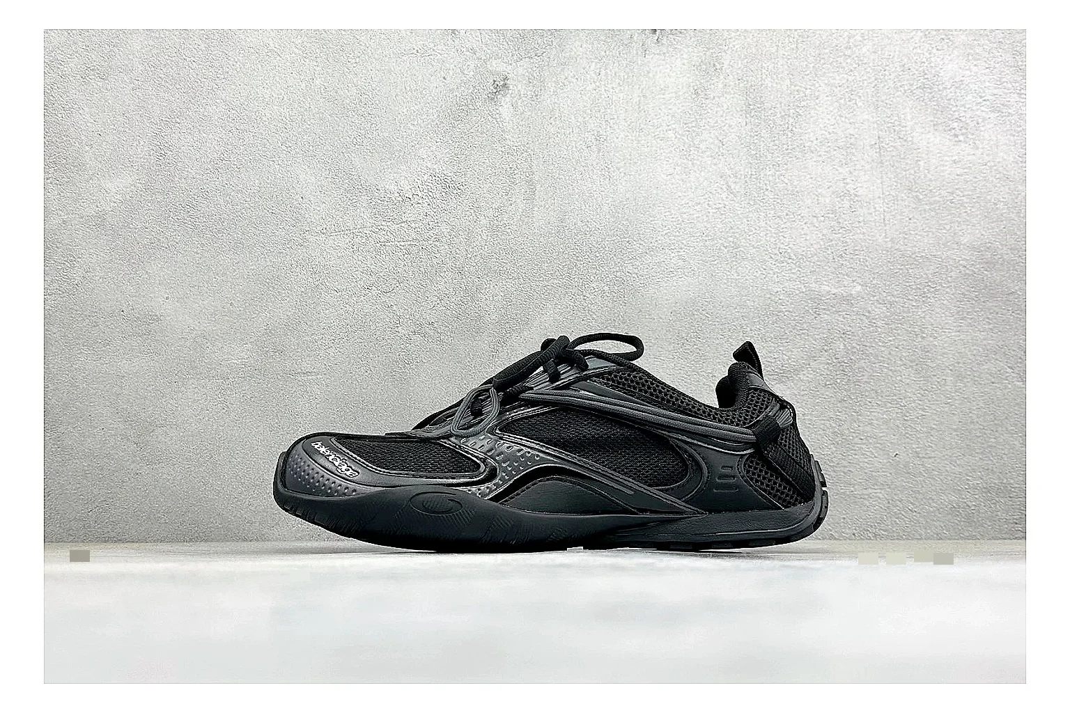 Balenciaga Track Black Low-Top comparison photo showing black layered technical upper, complex paneling, chunky runner sole, and tactical low-top shape