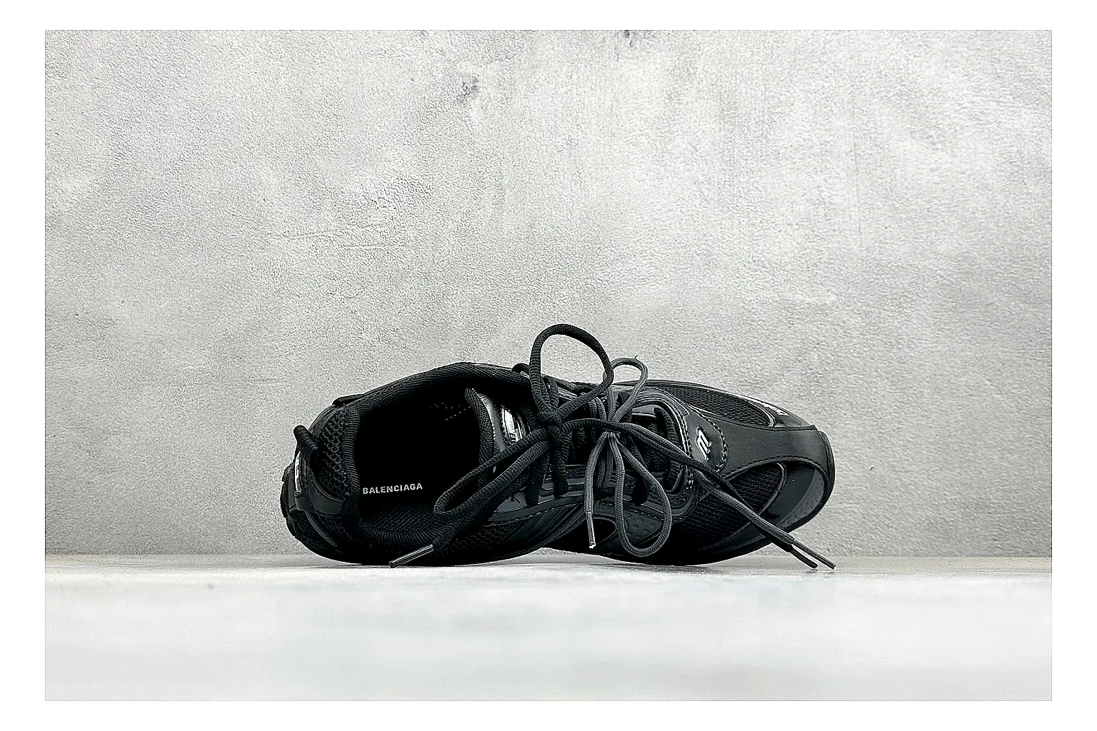 Balenciaga Track Black Low-Top comparison photo showing black layered technical upper, complex paneling, chunky runner sole, and tactical low-top shape