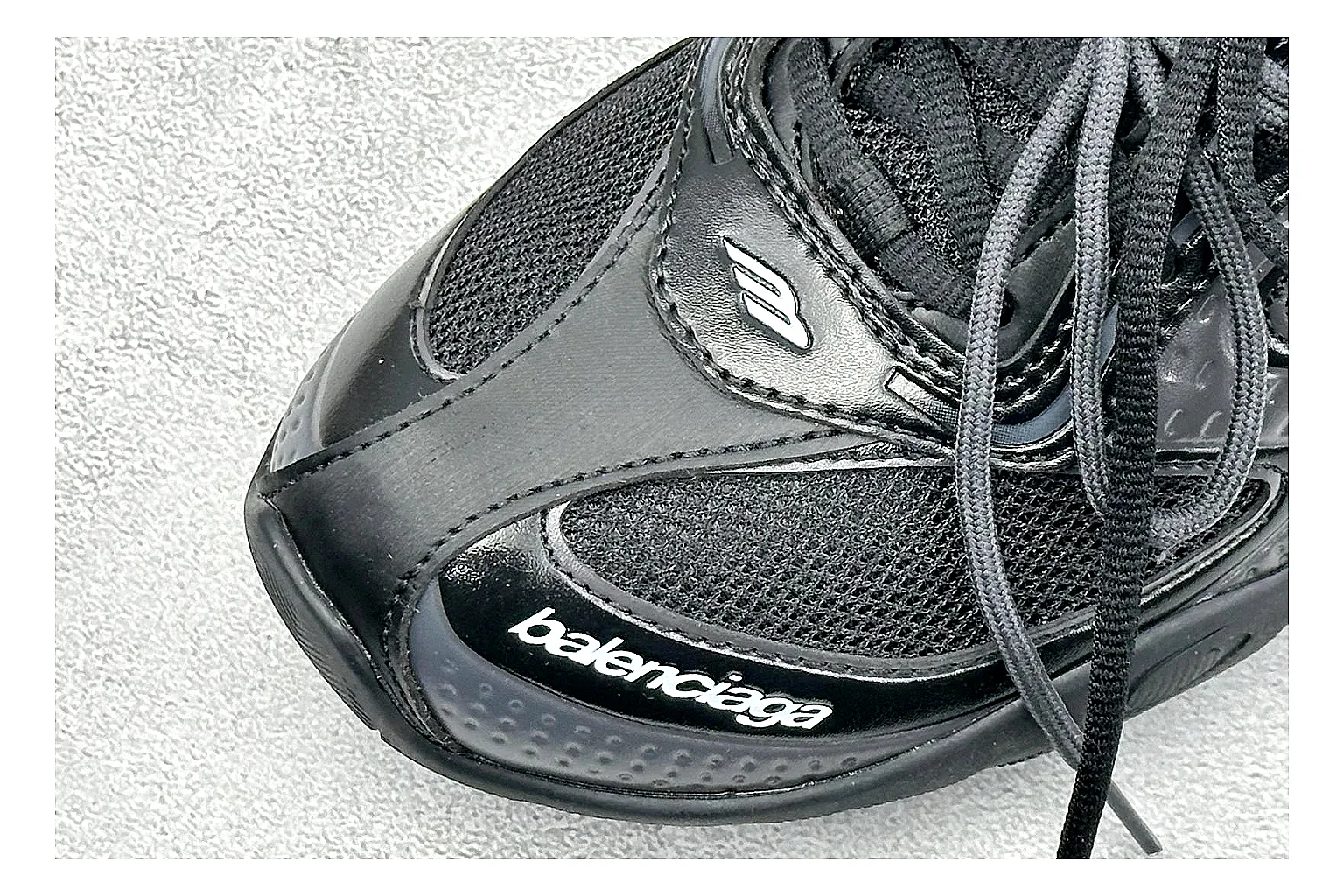 Balenciaga Track Black Low-Top comparison photo showing black layered technical upper, complex paneling, chunky runner sole, and tactical low-top shape thumbnail 5