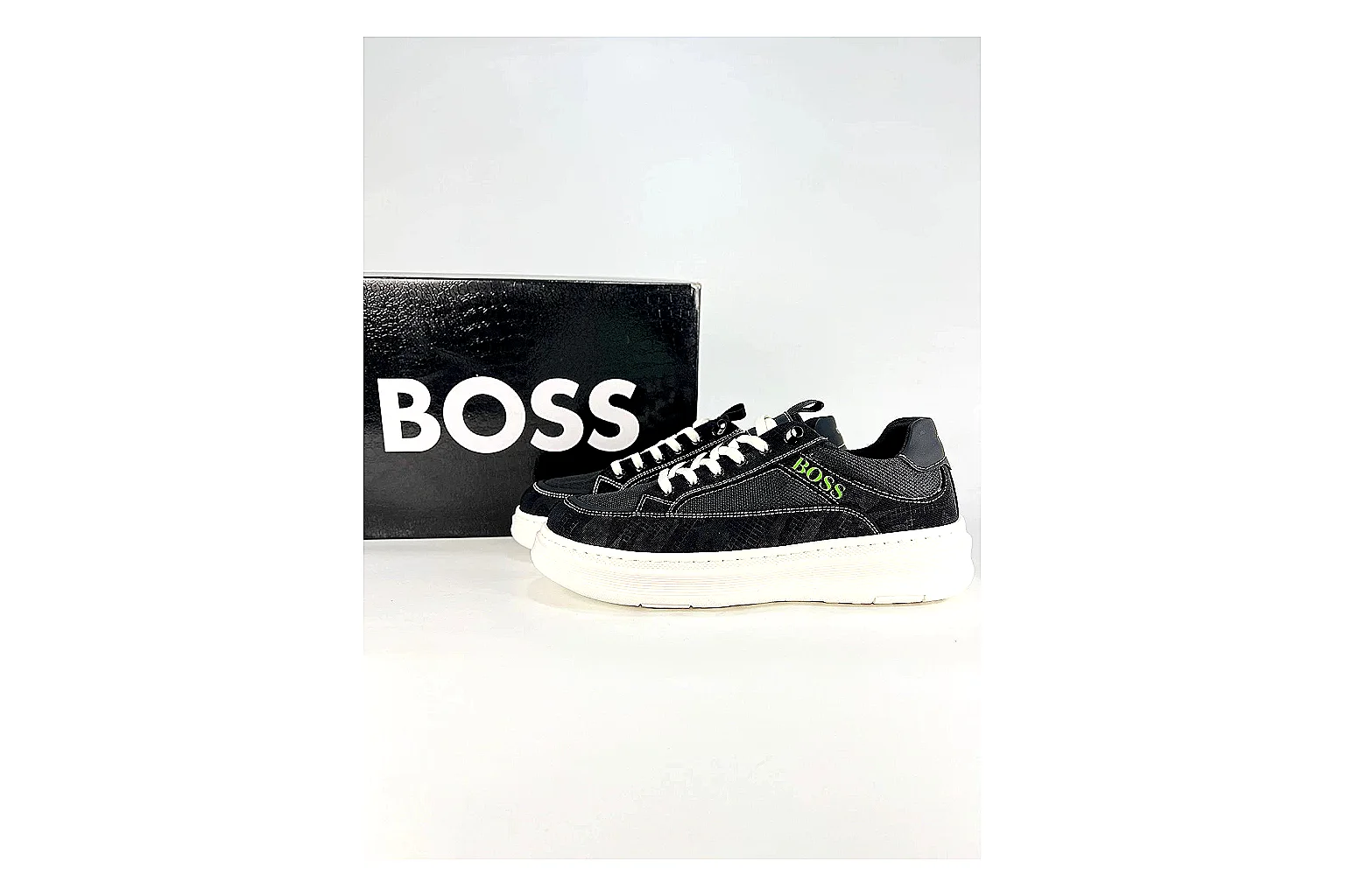 Boss Low Top Black White comparison photo showing black white leather low-top upper, minimal casual profile, clean panels, and simple rubber sole