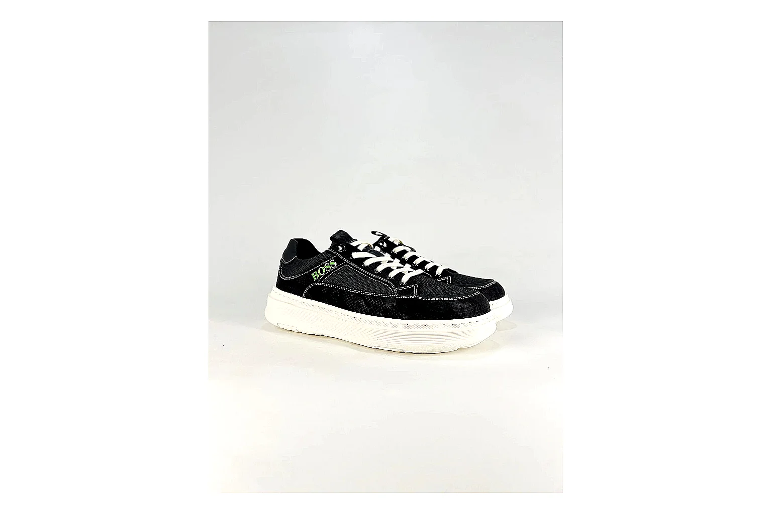 Boss Low Top Black White comparison photo showing black white leather low-top upper, minimal casual profile, clean panels, and simple rubber sole