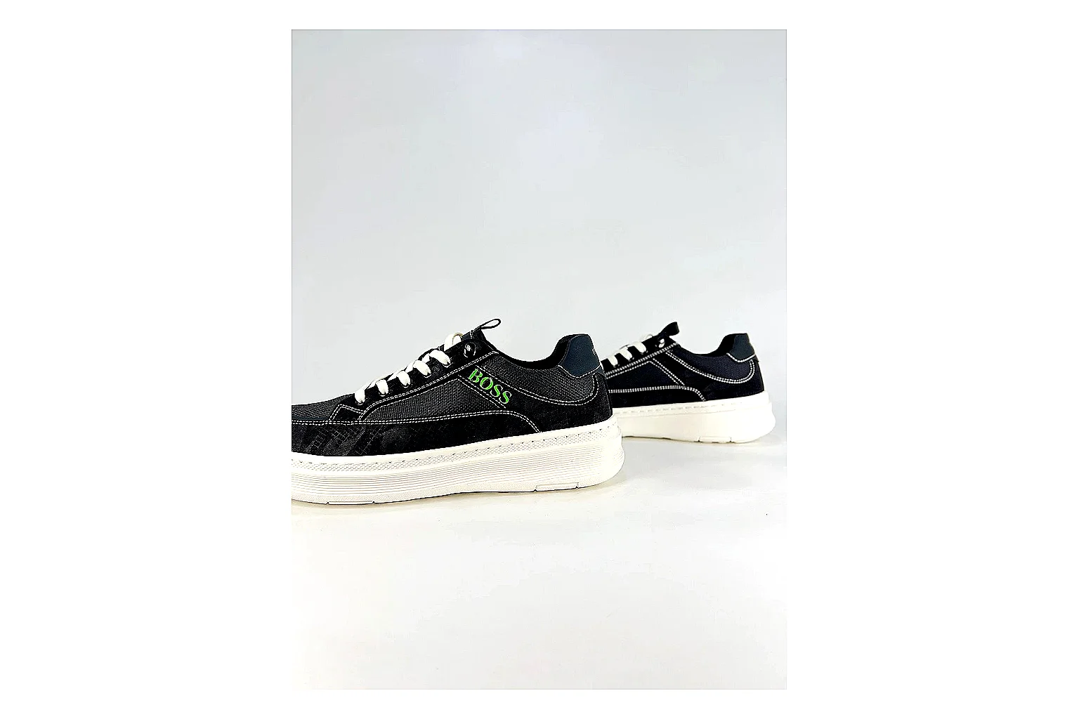 Boss Low Top Black White comparison photo showing black white leather low-top upper, minimal casual profile, clean panels, and simple rubber sole thumbnail 3