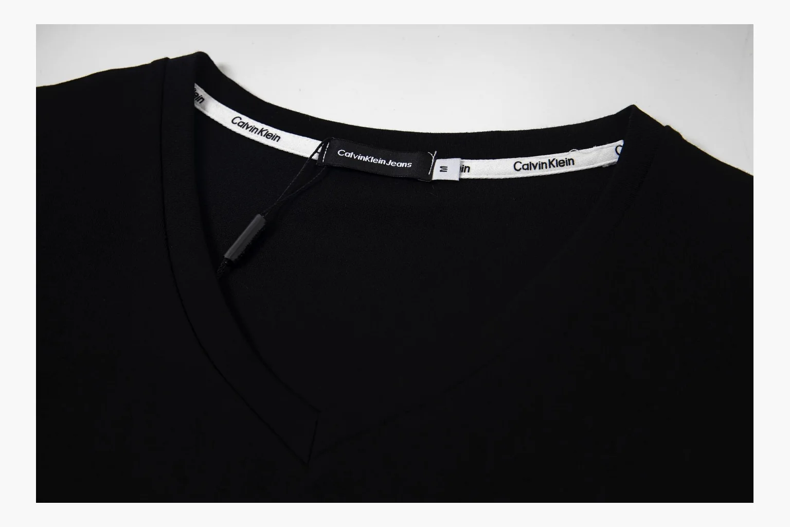 Calvin Klein black V-neck tee comparison image with print thumbnail 4