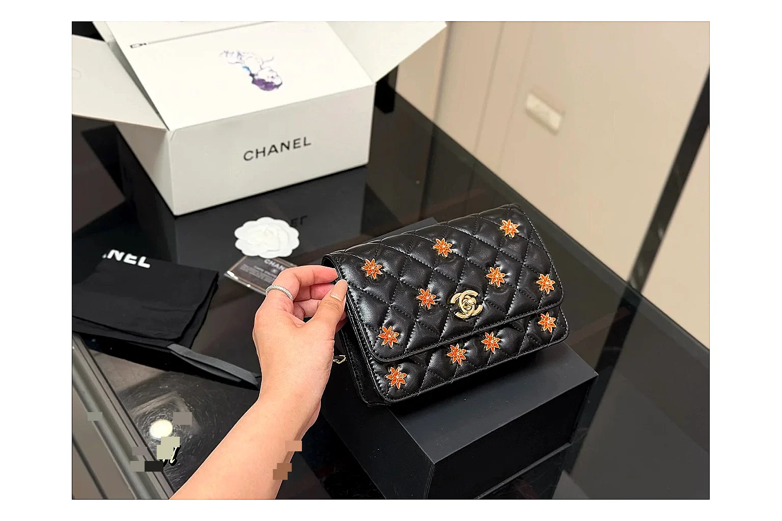 Chanel Quilted Wallet Bag Black Floral comparison photo showing black quilted wallet-bag body, floral detail, compact flap shape, and polished chain hardware