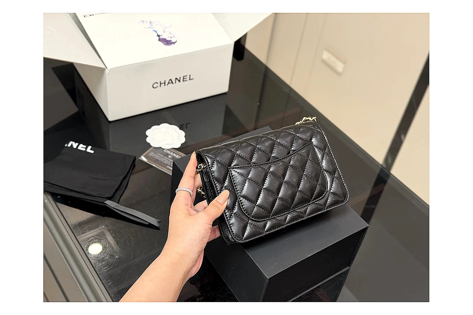 Chanel Quilted Wallet Bag Black Floral comparison photo showing black quilted wallet-bag body, floral detail, compact flap shape, and polished chain hardware thumbnail 5