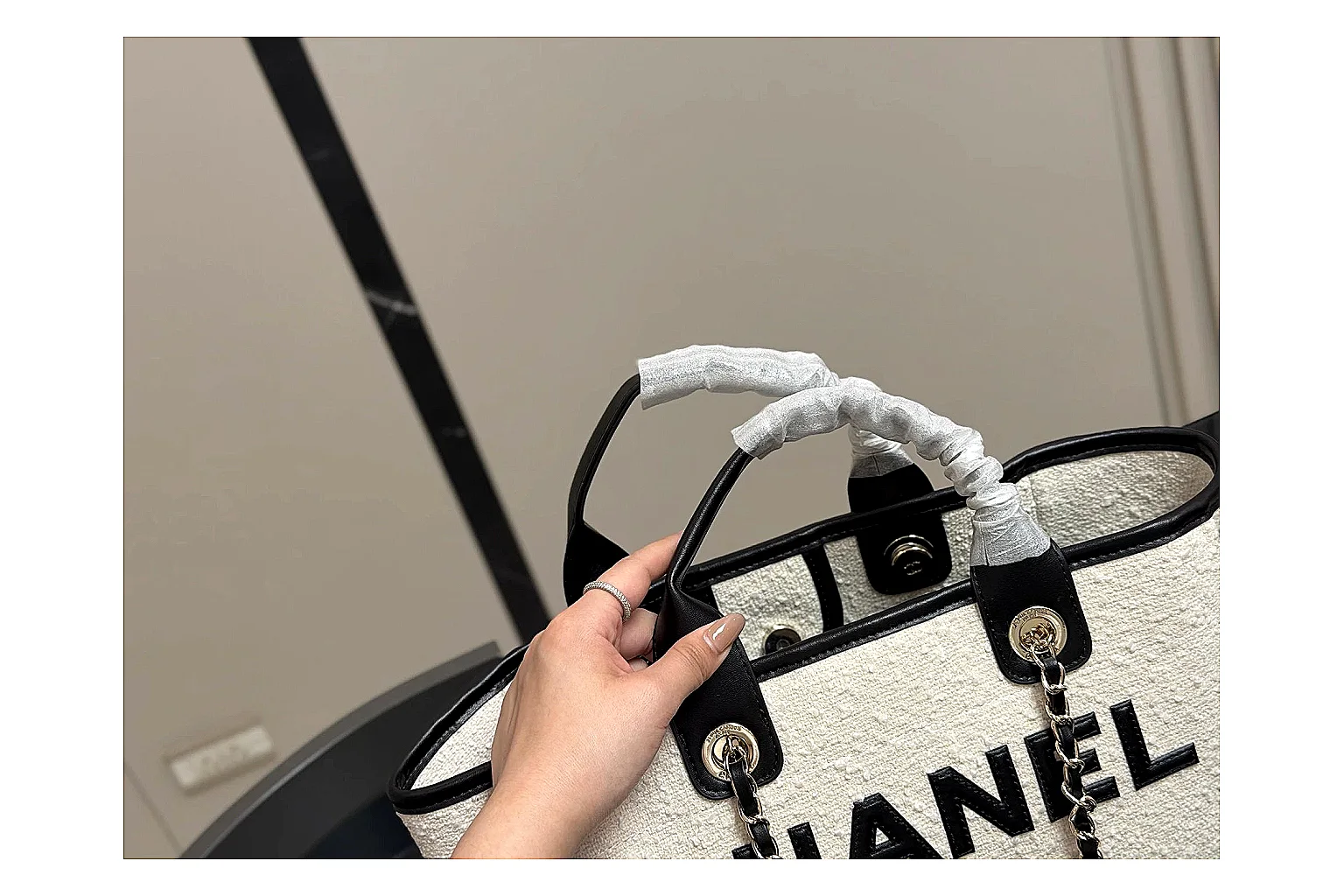 Chanel Tote Bag White Black comparison photo showing white black canvas-leather tote body, open carry shape, structured handles, and branded luxury-bag details thumbnail 2