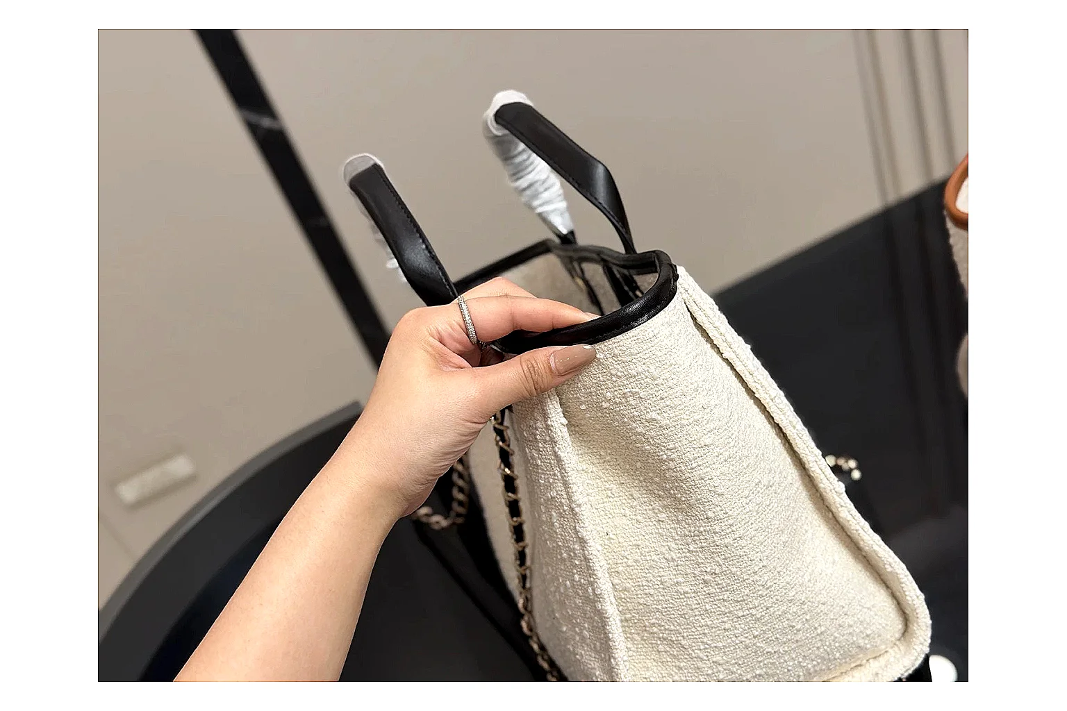 Chanel Tote Bag White Black comparison photo showing white black canvas-leather tote body, open carry shape, structured handles, and branded luxury-bag details thumbnail 3