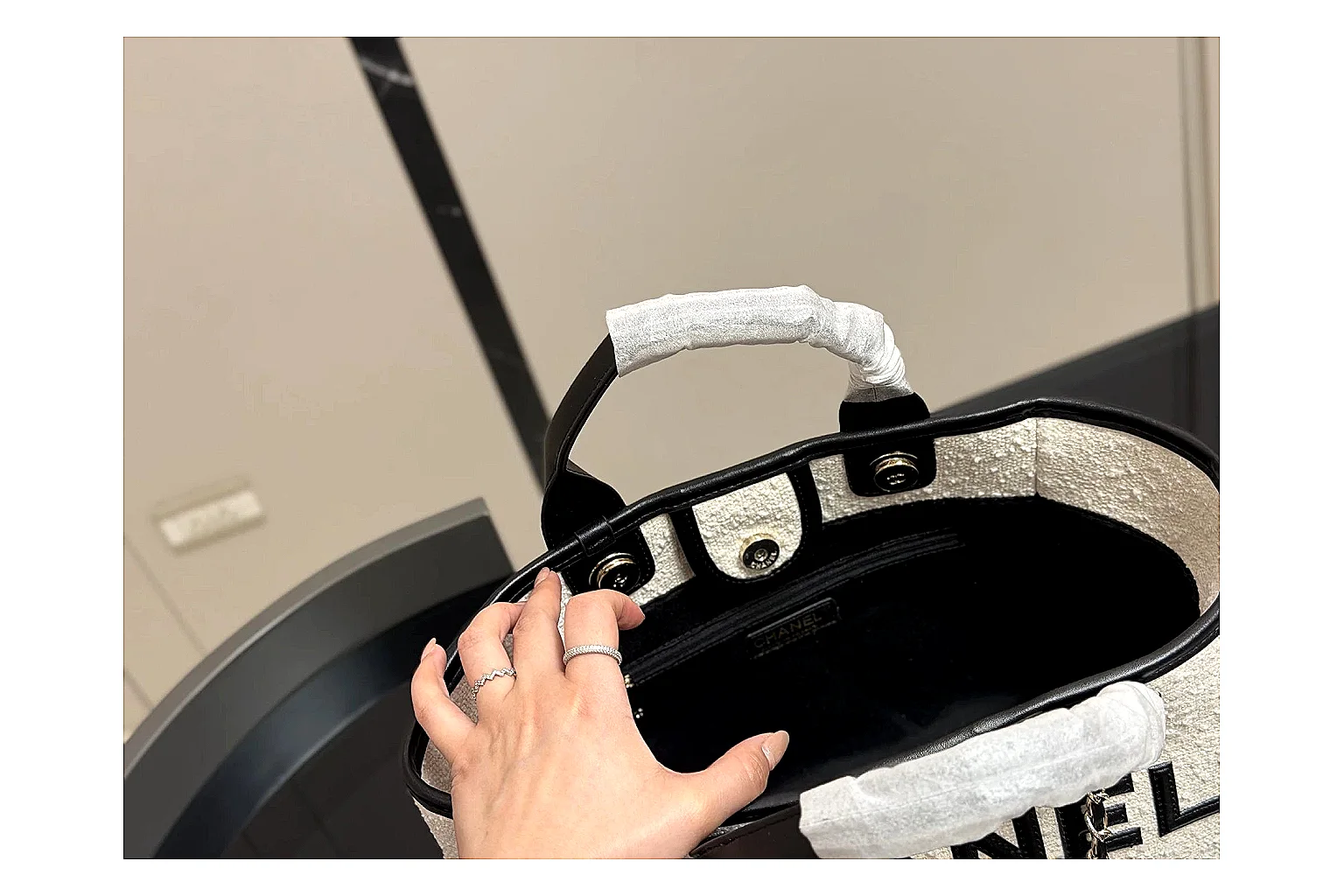 Chanel Tote Bag White Black comparison photo showing white black canvas-leather tote body, open carry shape, structured handles, and branded luxury-bag details thumbnail 4