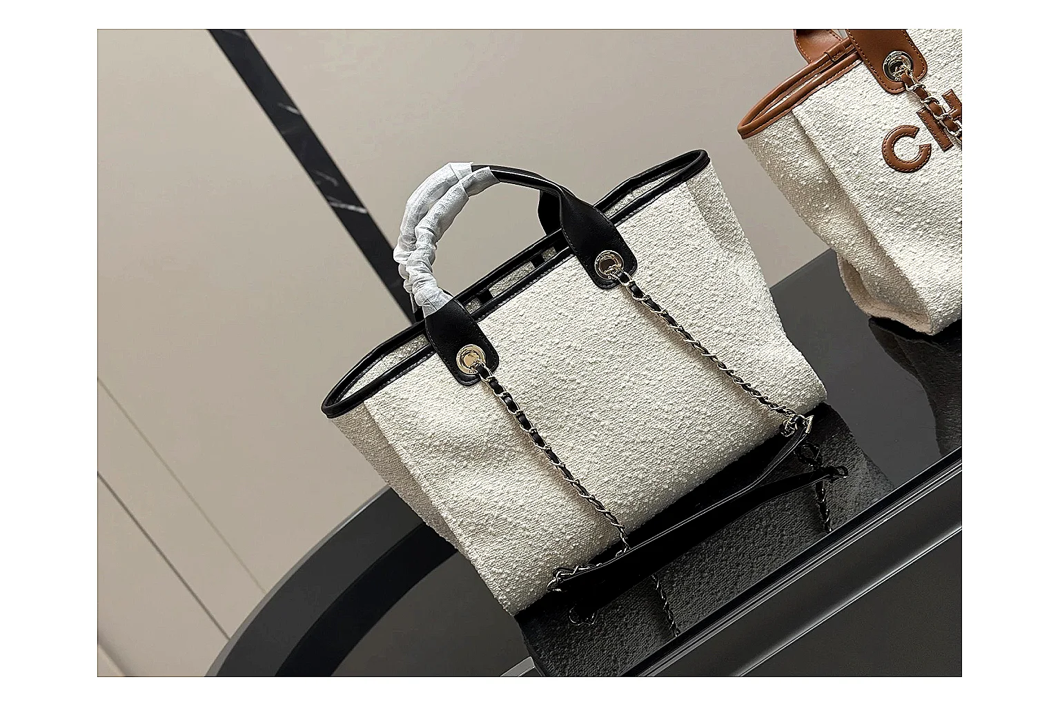 Chanel Tote Bag White Black comparison photo showing white black canvas-leather tote body, open carry shape, structured handles, and branded luxury-bag details thumbnail 5