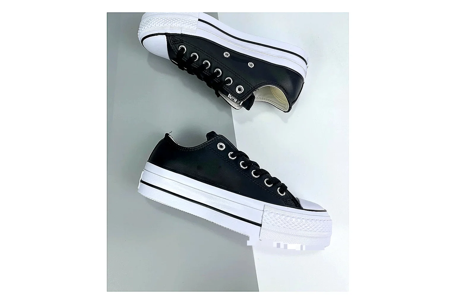 Converse All Star Lift Black Platform Low Top comparison photo showing black leather low-top upper, silver eyelets, white rubber toe cap, and elevated striped platform sole