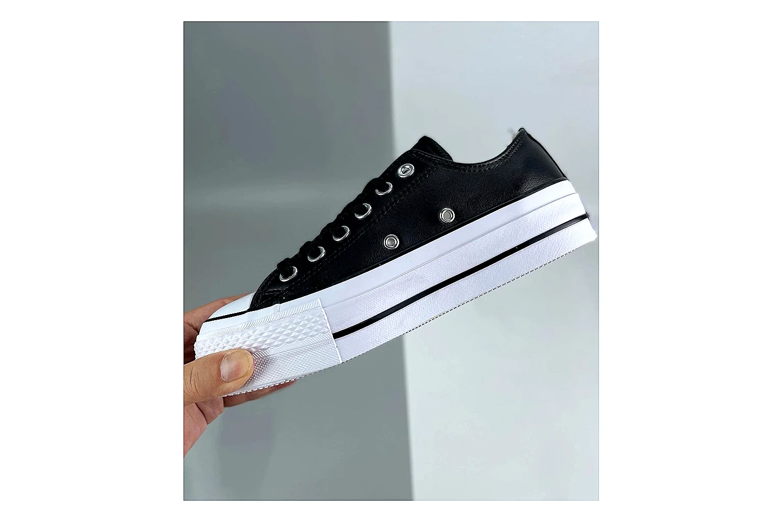 Converse All Star Lift Black Platform Low Top comparison photo showing black leather low-top upper, silver eyelets, white rubber toe cap, and elevated striped platform sole thumbnail 3