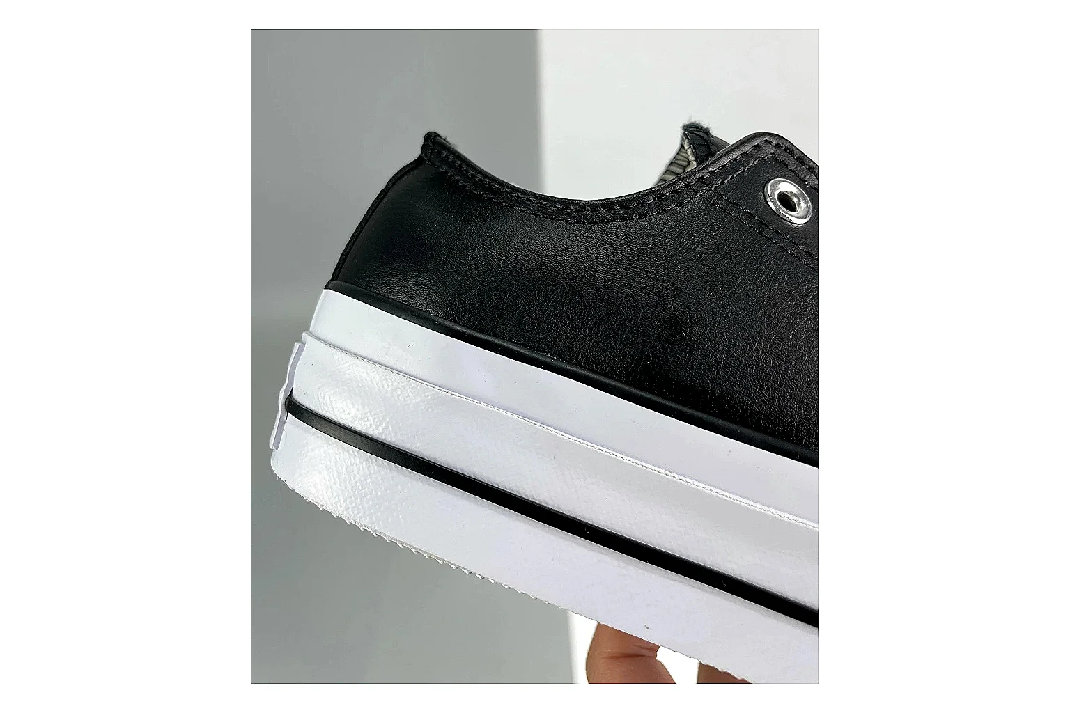 Converse All Star Lift Black Platform Low Top comparison photo showing black leather low-top upper, silver eyelets, white rubber toe cap, and elevated striped platform sole thumbnail 5