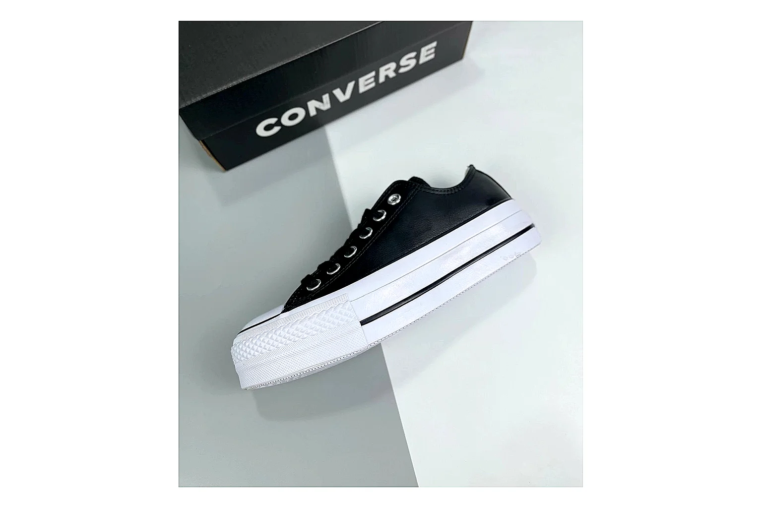 Converse All Star Lift Black Platform Low Top comparison photo showing black leather low-top upper, silver eyelets, white rubber toe cap, and elevated striped platform sole thumbnail 6