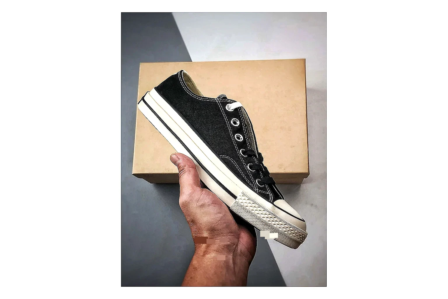 Converse Chuck Low Black White comparison photo showing black canvas low-top upper, white rubber toe cap, metal eyelets, and classic Converse sole