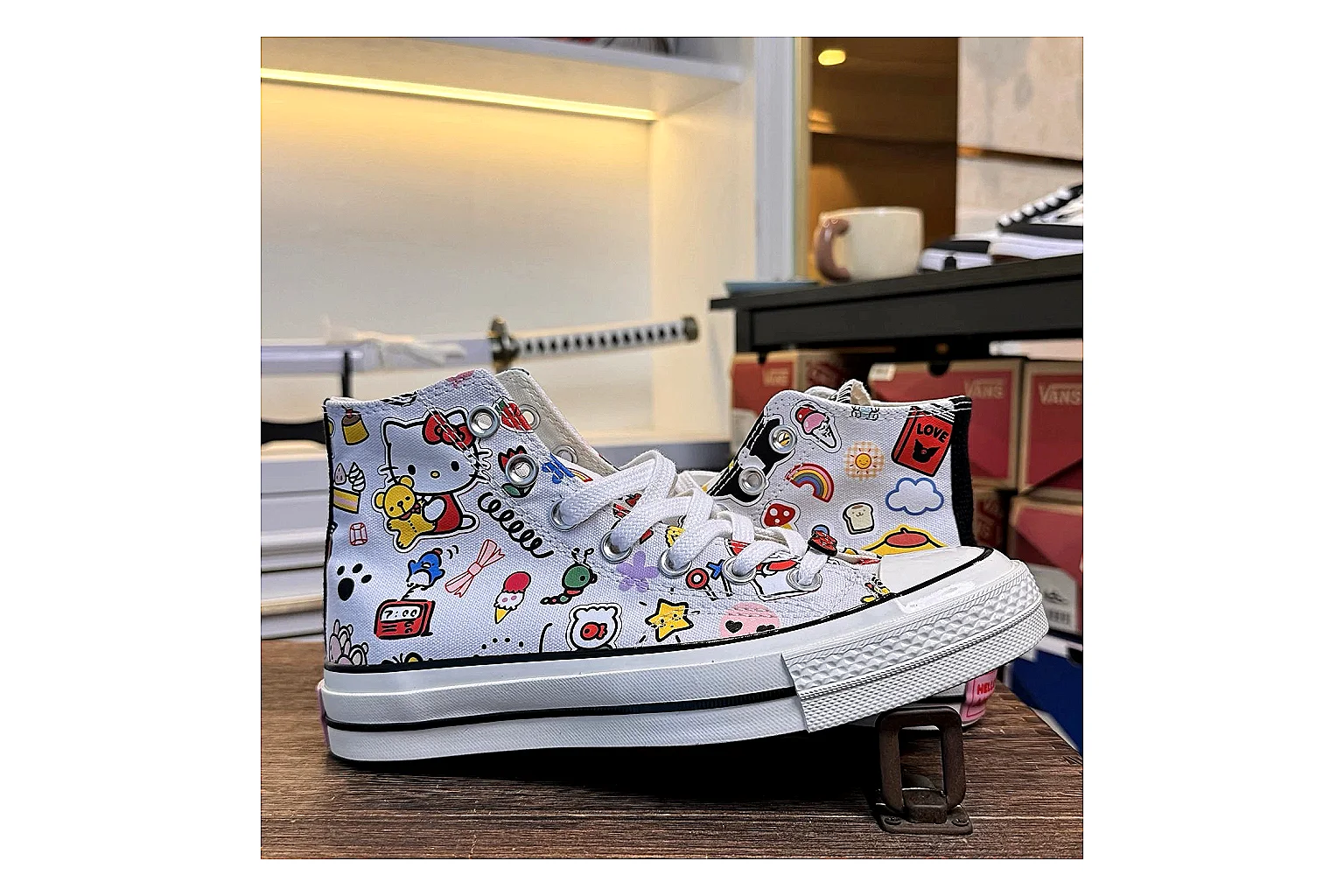 Converse Hello Kitty Chuck 70 High Top comparison photo showing white canvas high-top upper, colorful character graphics, metal eyelets, rubber toe cap, and elevated vintage sole thumbnail 2