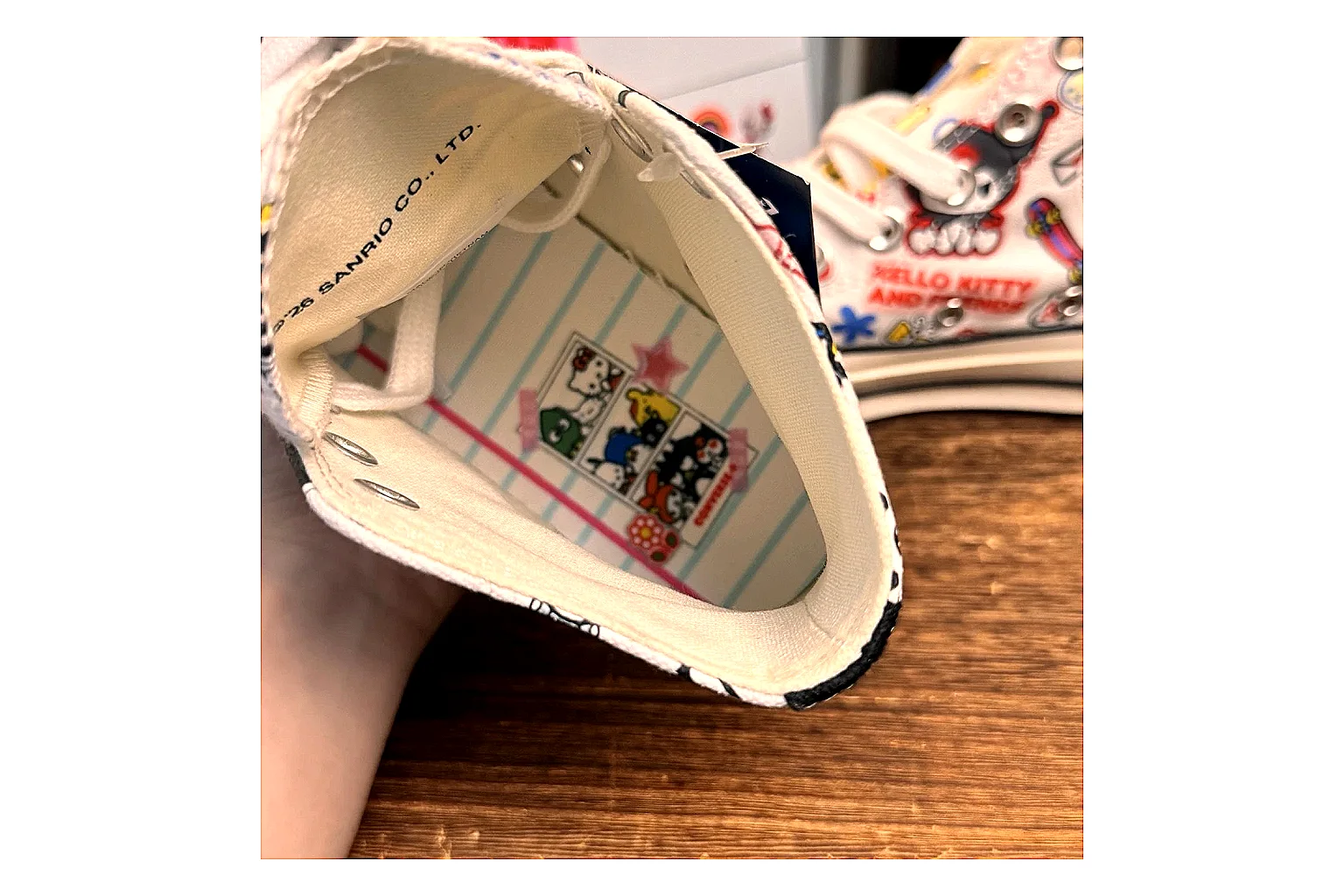 Converse Hello Kitty Chuck 70 High Top comparison photo showing white canvas high-top upper, colorful character graphics, metal eyelets, rubber toe cap, and elevated vintage sole thumbnail 3