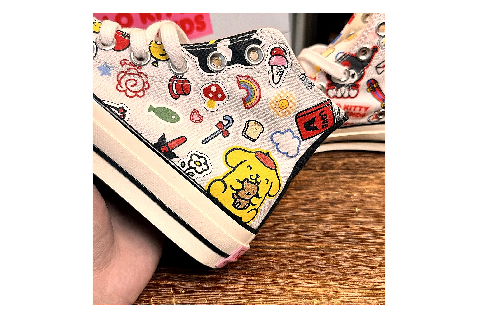 Converse Hello Kitty Chuck 70 High Top comparison photo showing white canvas high-top upper, colorful character graphics, metal eyelets, rubber toe cap, and elevated vintage sole thumbnail 5