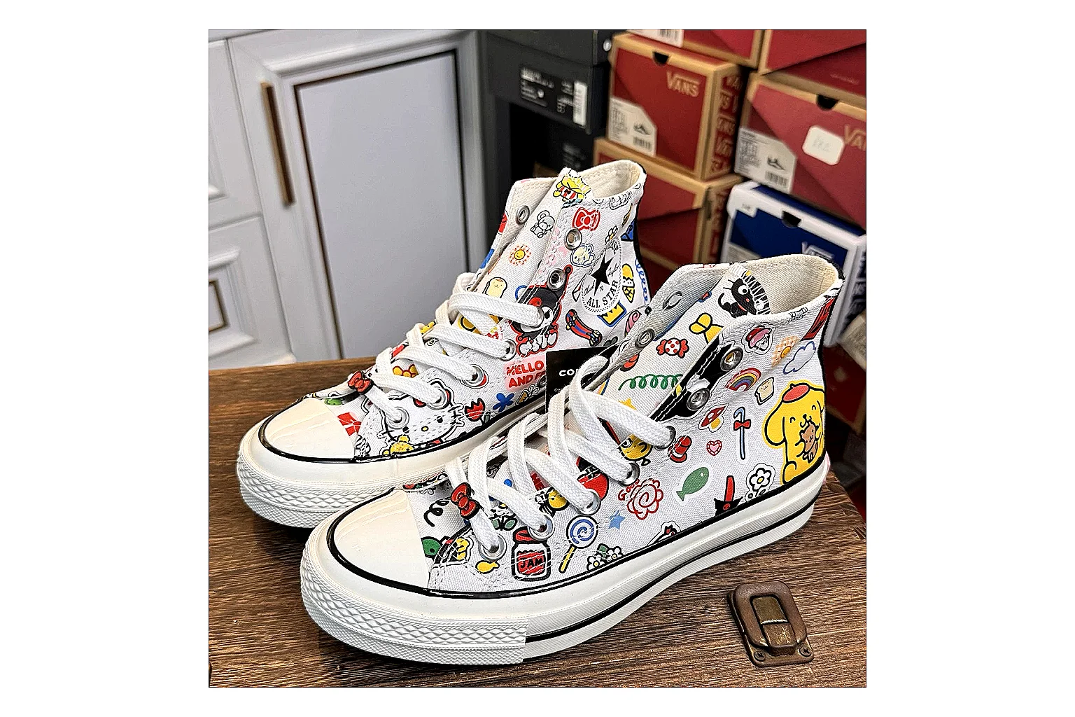 Converse Hello Kitty Chuck 70 High Top comparison photo showing white canvas high-top upper, colorful character graphics, metal eyelets, rubber toe cap, and elevated vintage sole thumbnail 6