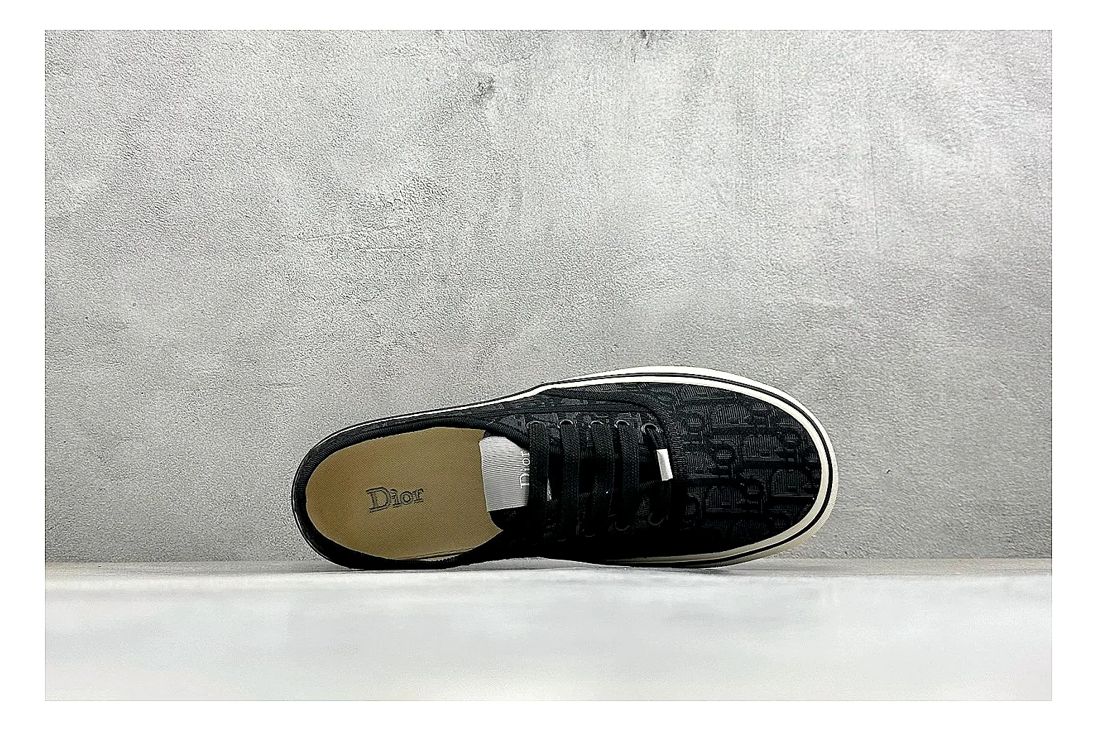 Dior Act Slide Black Low-Top comparison photo showing black monogram-style upper, low slip-on shape, chunky dark sole, and luxury casual profile
