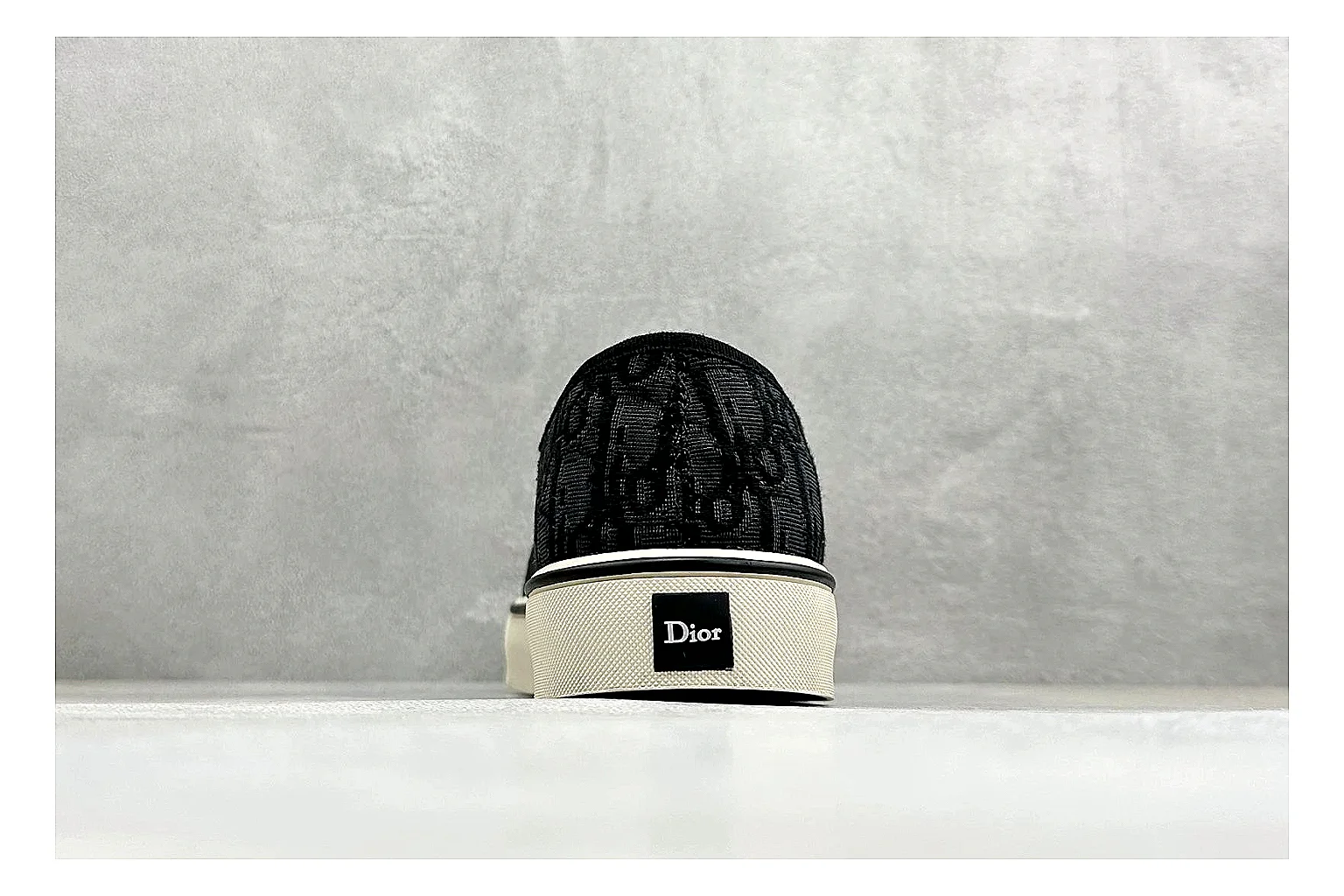 Dior Act Slide Black Low-Top comparison photo showing black monogram-style upper, low slip-on shape, chunky dark sole, and luxury casual profile thumbnail 3
