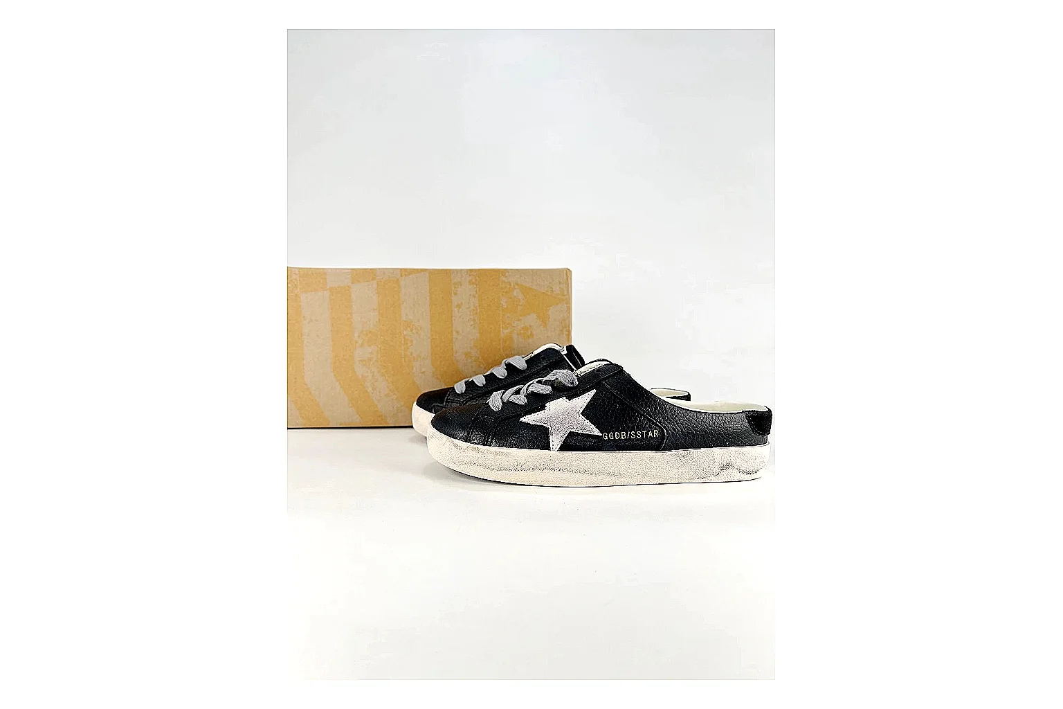 GGDB Super-Star Black White Sneakers comparison signal photo with black white distressed low-top sneakers with leather texture, side-profile shape, upper panel lines, and outsole detail