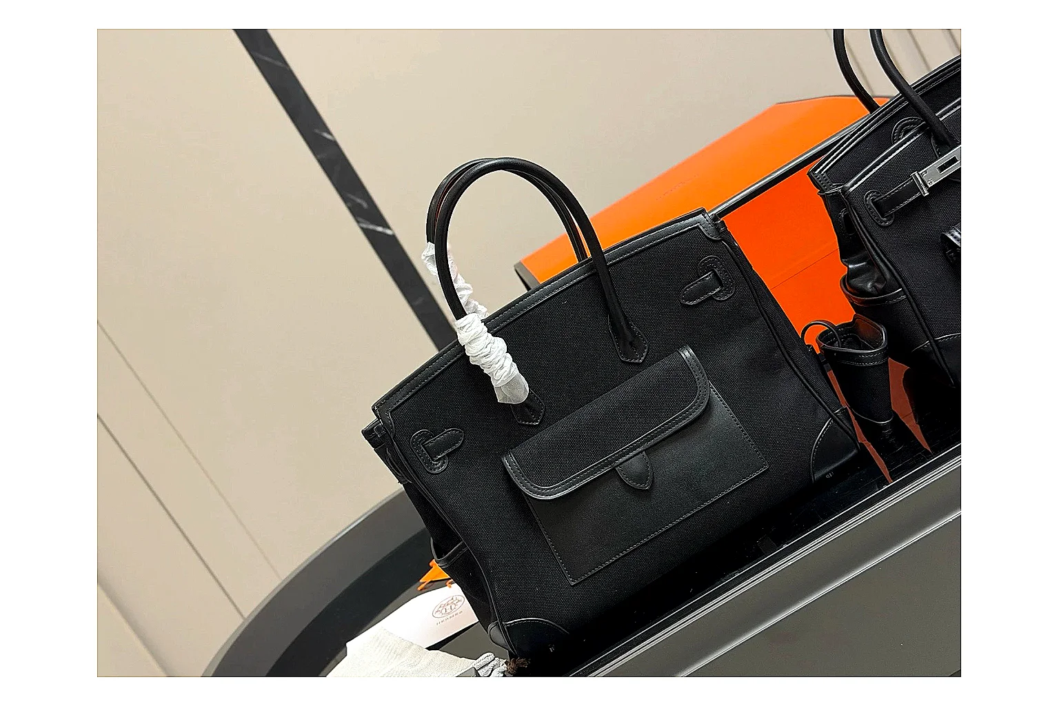 Hermes Birkin Style Black comparison photo showing black leather structured body, top handles, flap-and-strap shape, and polished hardware thumbnail 5