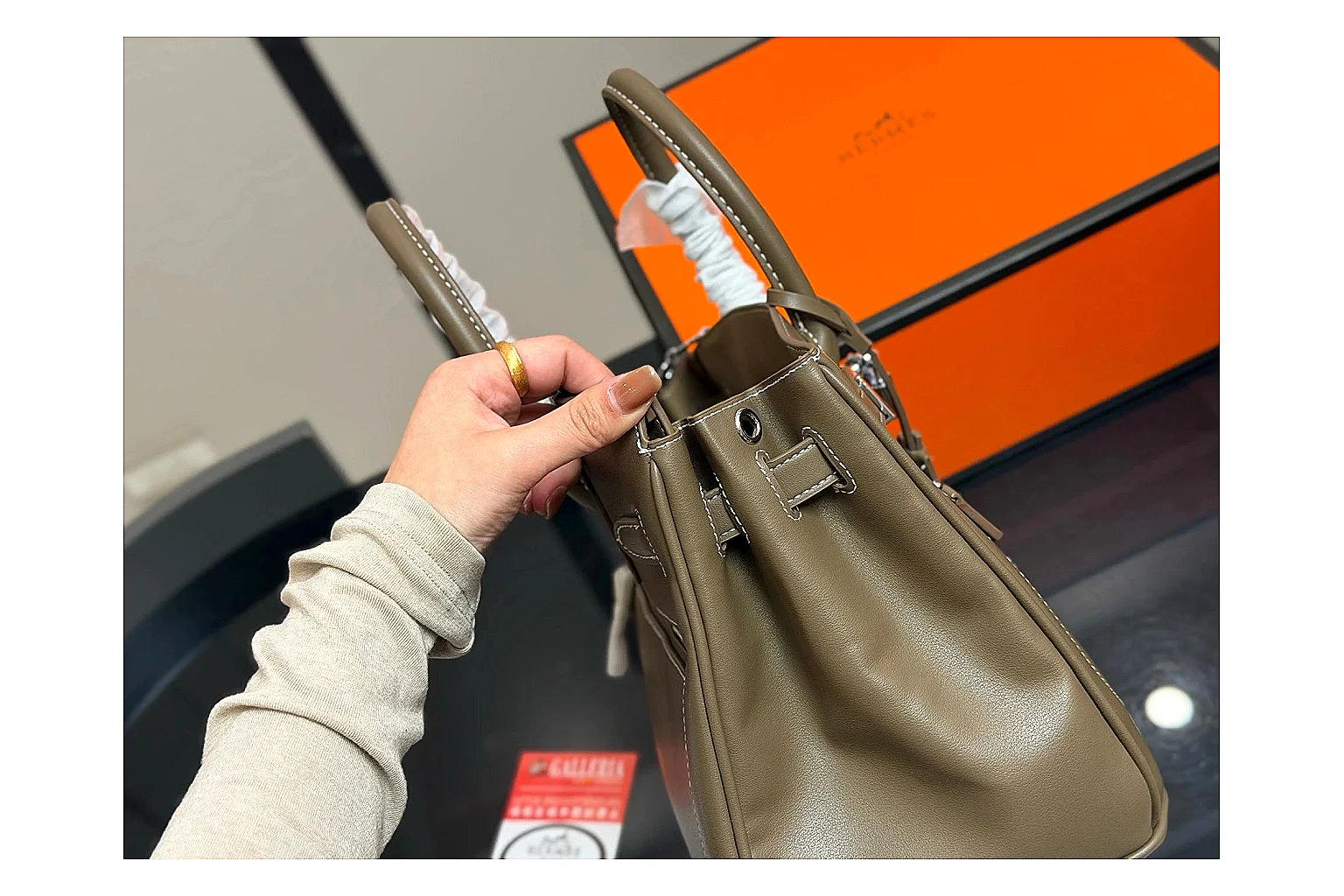 Hermes Birkin Style Olive comparison photo showing olive leather structured body, top handles, flap-and-strap shape, and polished hardware thumbnail 3