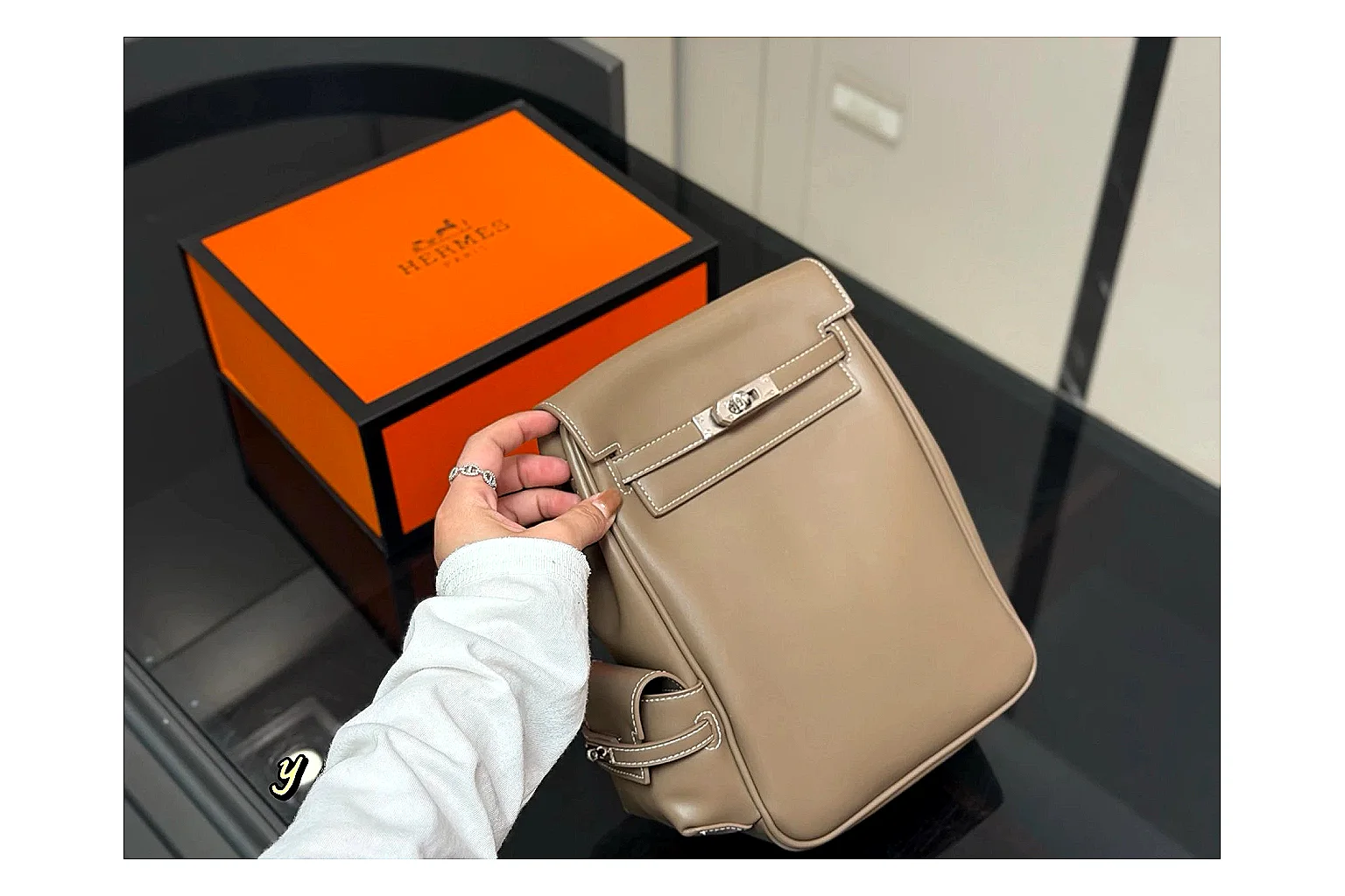 Hermes Kelly Backpack Beige comparison photo showing beige leather backpack body, Kelly-style flap, top handle, shoulder straps, and polished hardware thumbnail 6