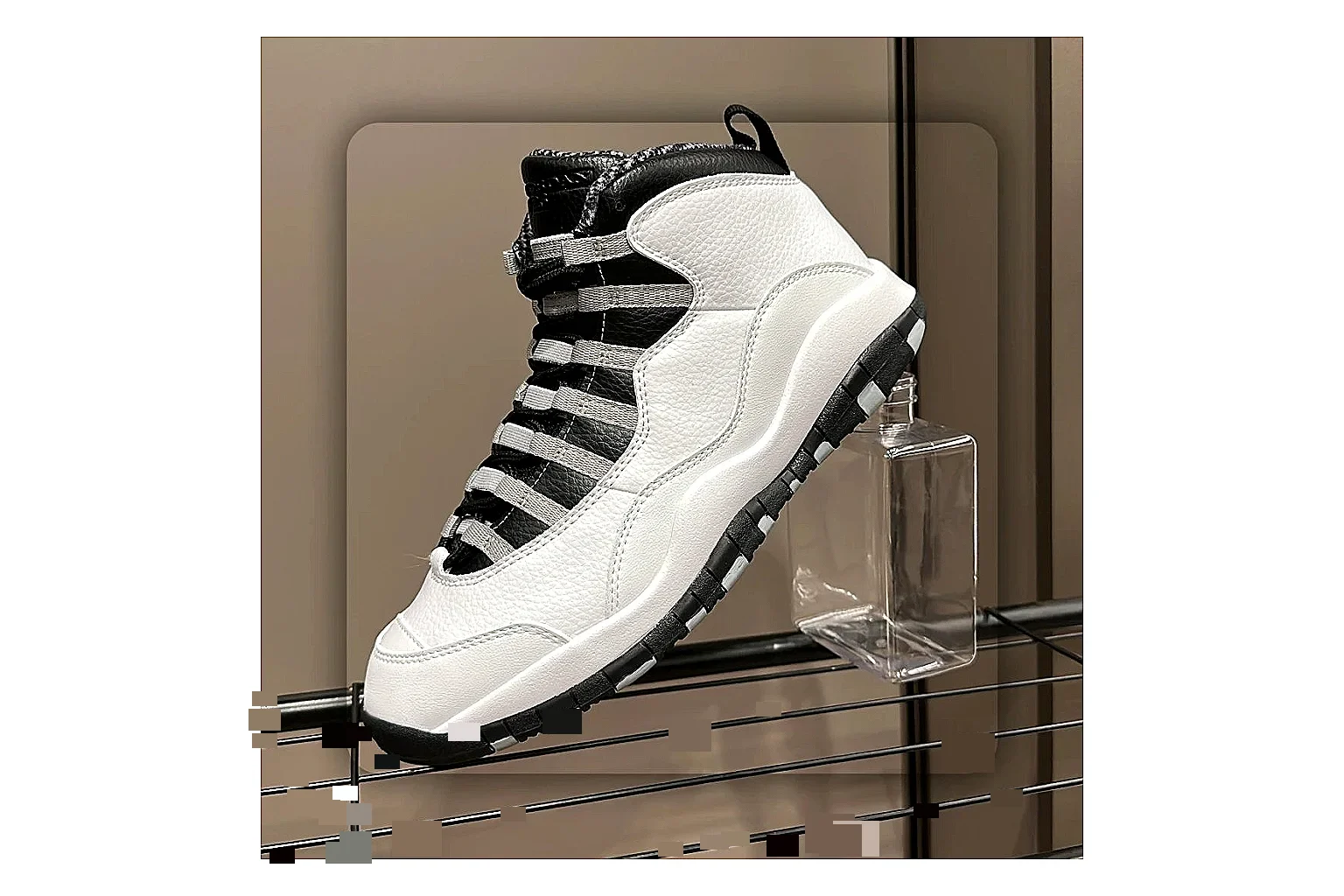Jordan Air Jordan 10 Steel White Black comparison photo showing white and black high-top court upper, striped lace panels, Jumpman heel branding, and retro sole