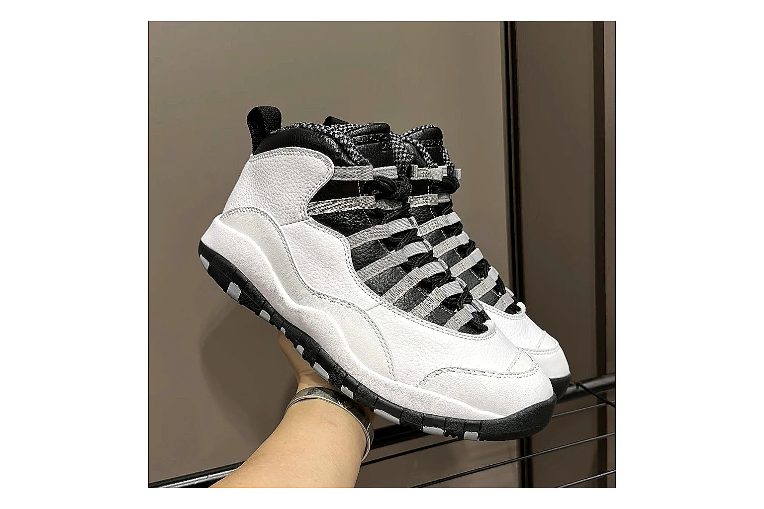 Jordan Air Jordan 10 Steel White Black comparison photo showing white and black high-top court upper, striped lace panels, Jumpman heel branding, and retro sole thumbnail 2
