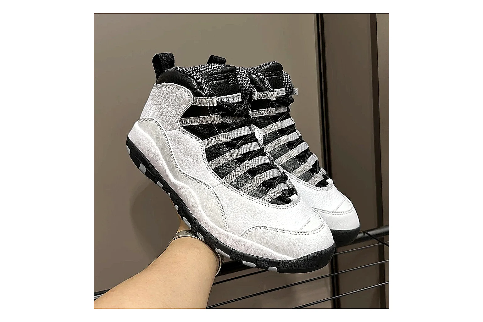 Jordan Air Jordan 10 Steel White Black comparison photo showing white and black high-top court upper, striped lace panels, Jumpman heel branding, and retro sole thumbnail 3
