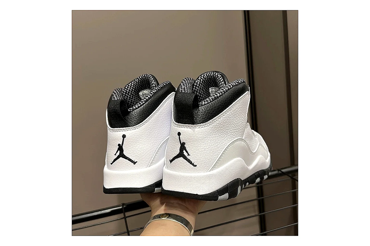 Jordan Air Jordan 10 Steel White Black comparison photo showing white and black high-top court upper, striped lace panels, Jumpman heel branding, and retro sole thumbnail 4