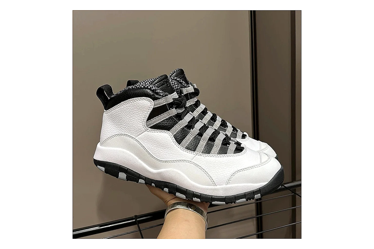 Jordan Air Jordan 10 Steel White Black comparison photo showing white and black high-top court upper, striped lace panels, Jumpman heel branding, and retro sole thumbnail 6