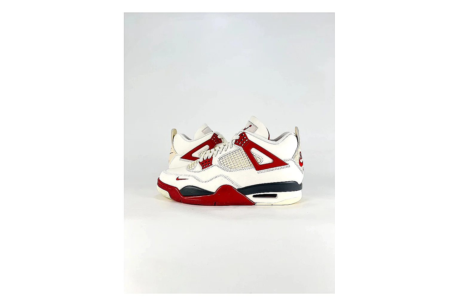 Jordan Air Jordan 4 White Red Sneakers comparison signal photo with white red retro basketball sneakers with leather texture, side-profile shape, upper panel lines, and outsole detail