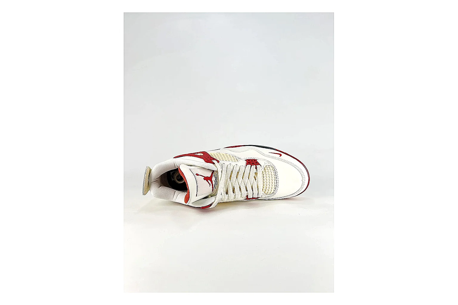Jordan Air Jordan 4 White Red Sneakers comparison signal photo with white red retro basketball sneakers with leather texture, side-profile shape, upper panel lines, and outsole detail thumbnail 2
