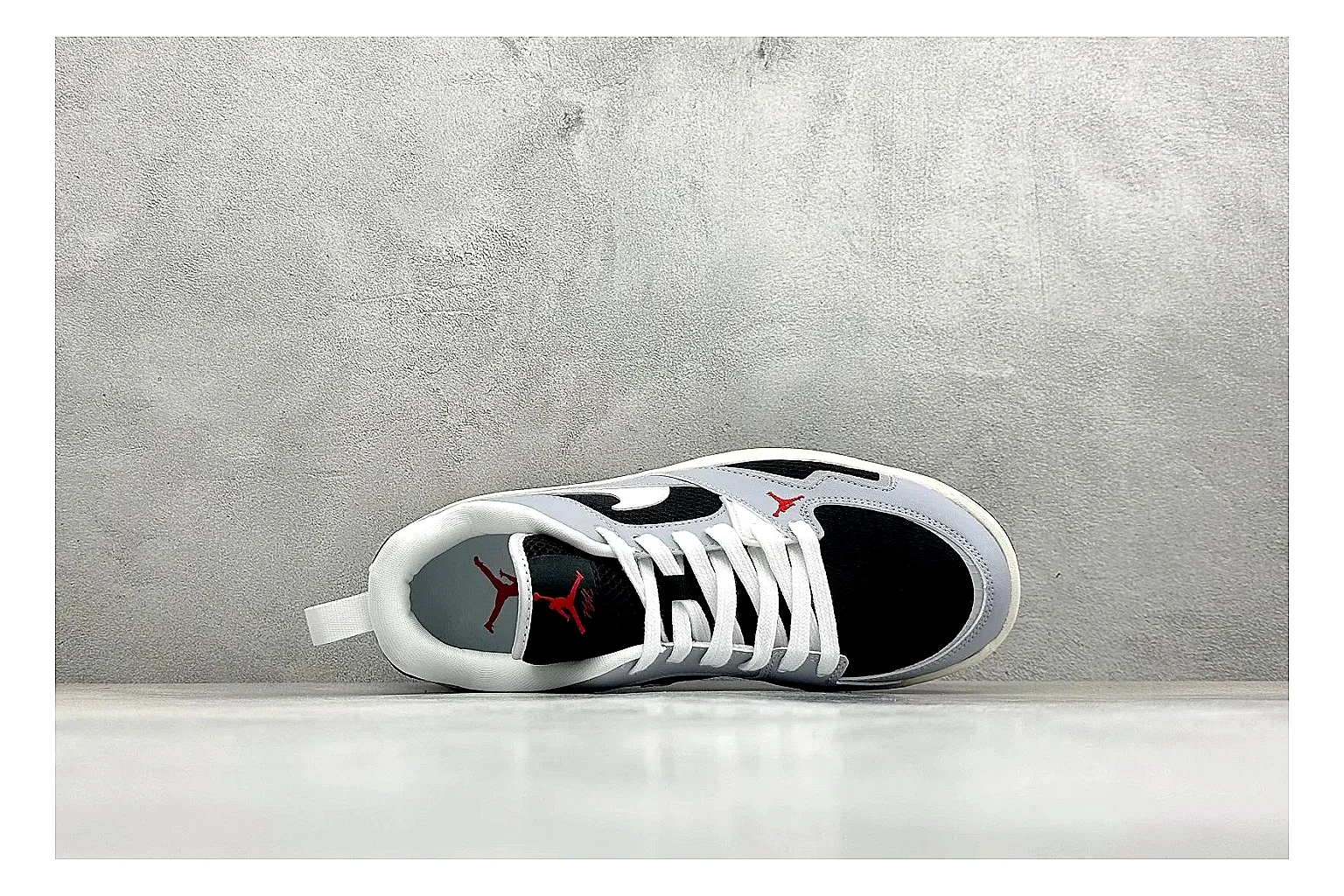 Jordan CMFT Black White comparison photo showing black and white layered panels, low padded collar, visible Jordan styling cues, and a compact court sole