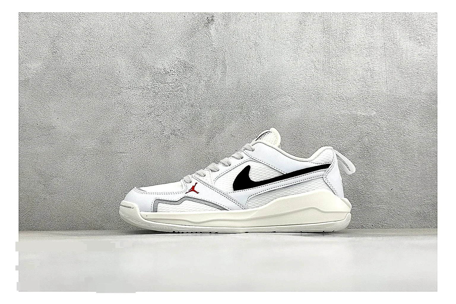 Jordan CMFT White Black comparison photo showing white and black layered court panels, red logo detail, low collar, and a clean contrast sole