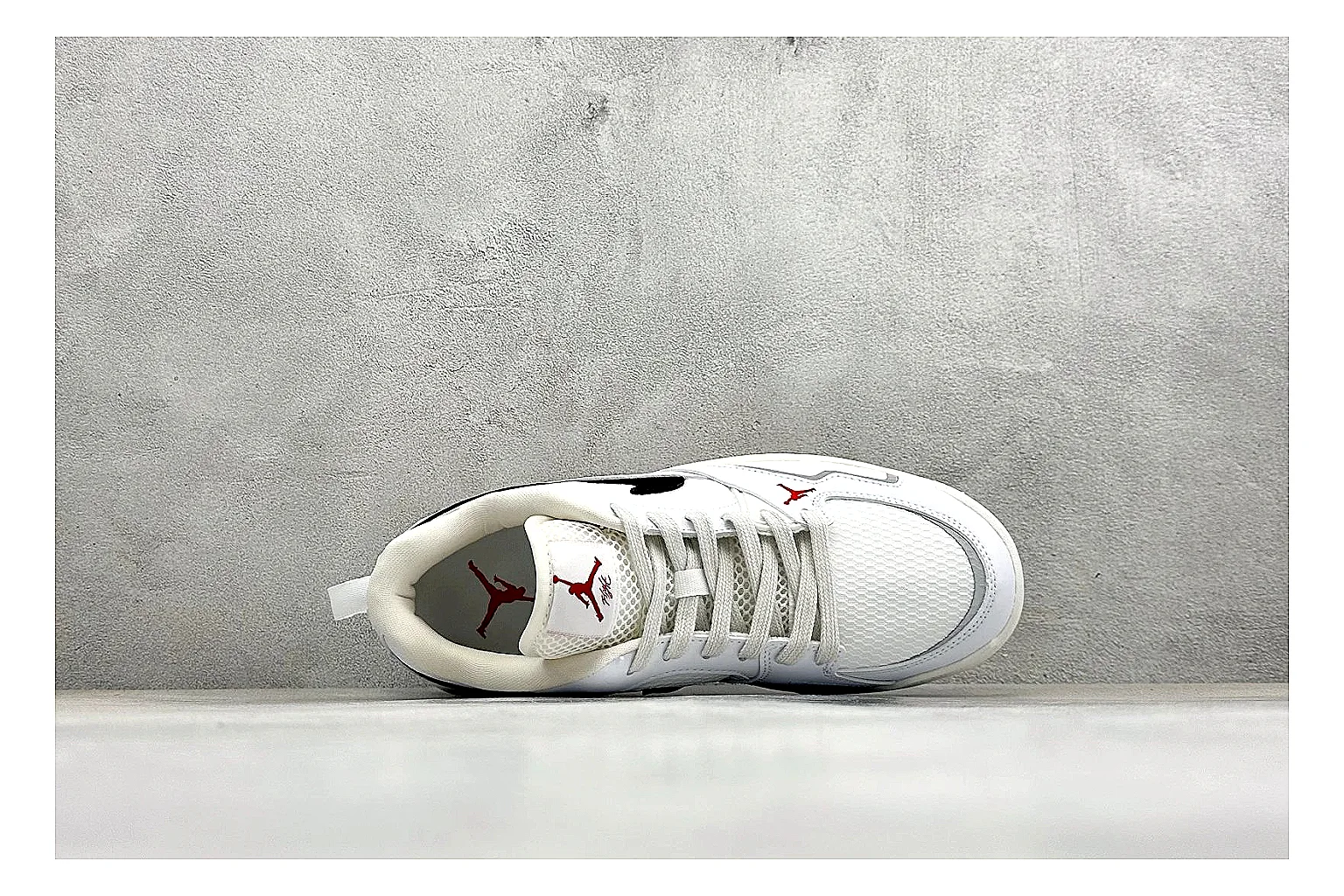 Jordan CMFT White Black comparison photo showing white and black layered court panels, red logo detail, low collar, and a clean contrast sole
