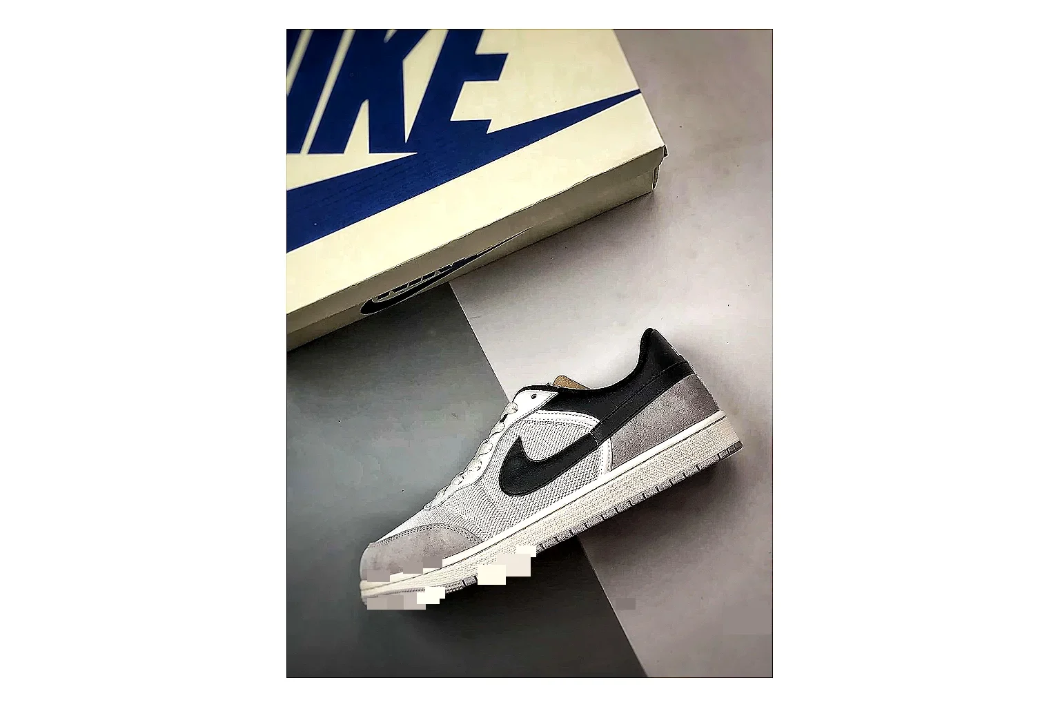 Jordan Low Black White Sneaker comparison signal photo with white black low-top sneaker with mixed-material upper and low-profile shape