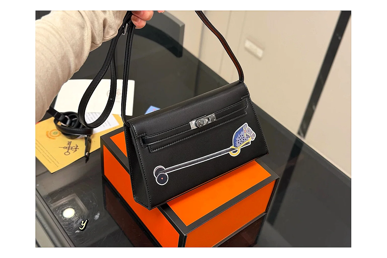 Louis Vuitton Wallet On Chain Black comparison photo showing black leather wallet-bag body, compact flap shape, chain strap, and polished LV-style hardware thumbnail 6